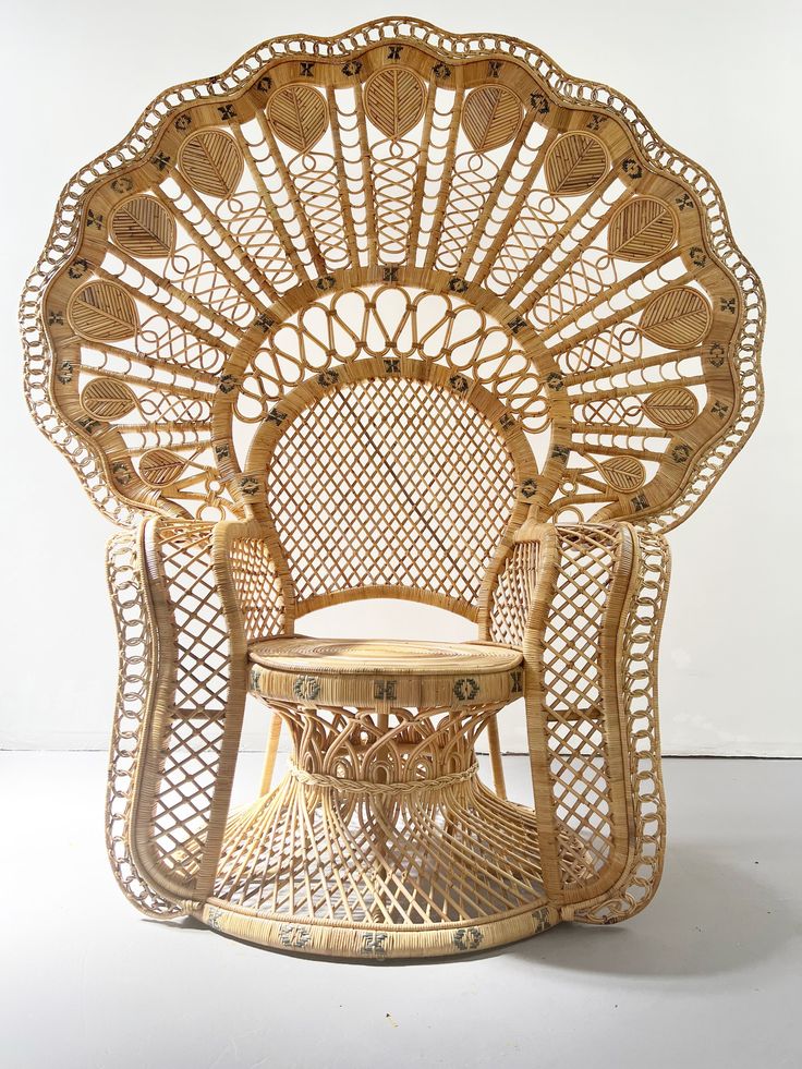 a wicker chair with a table in the middle and an intricately designed back