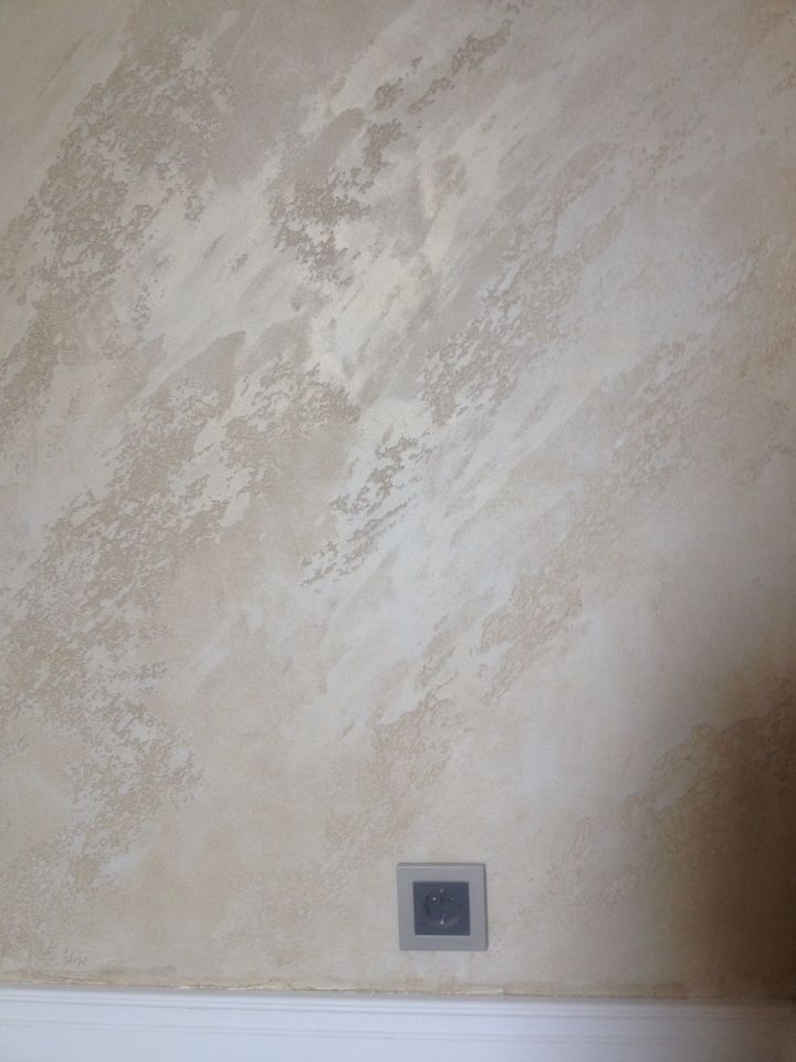 a bathroom wall that has a light switch on it and no one is in the room