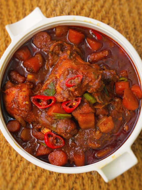 a bowl filled with meat and vegetables on top of a table