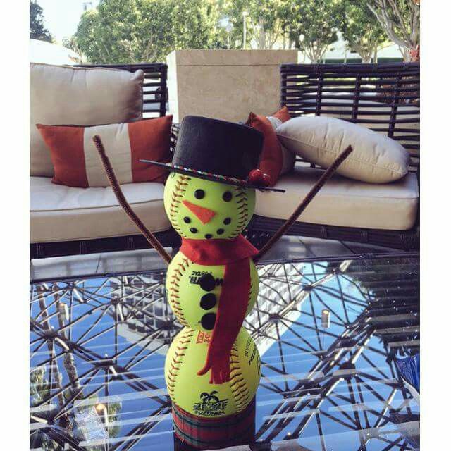 a decorated snowman sitting on top of a glass table