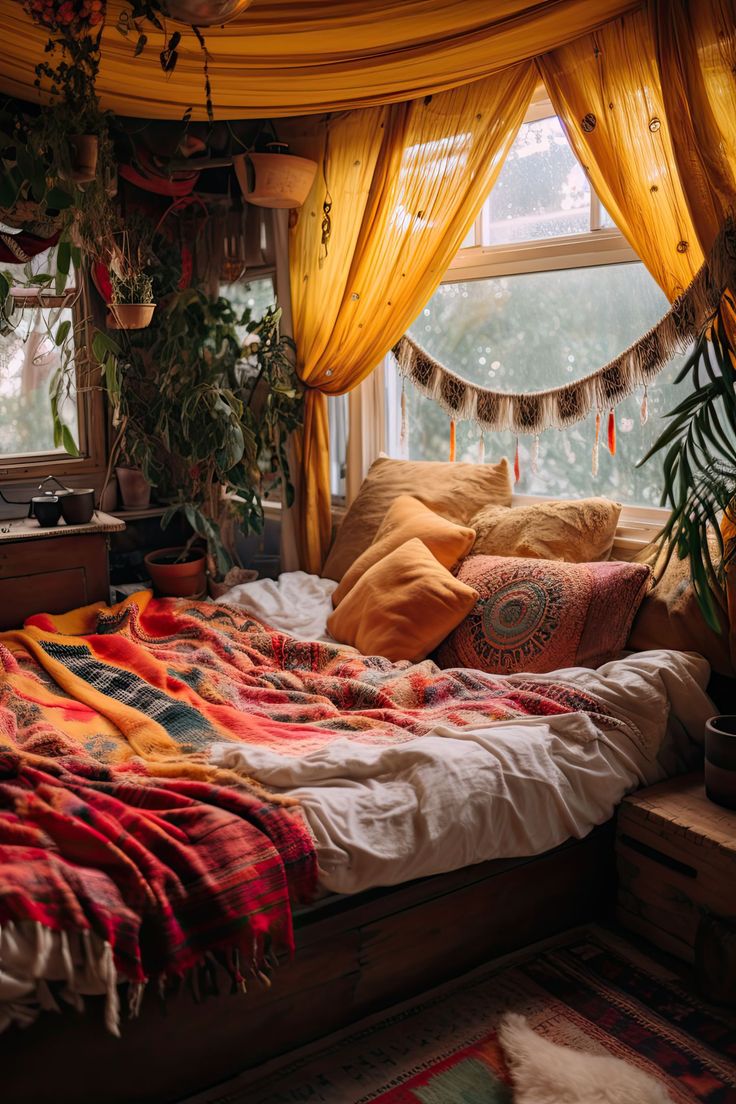 a bed sitting under a window next to a potted plant