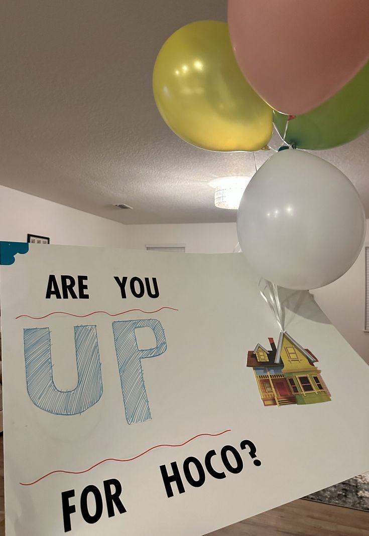 a sign that says are you up for hoco? with balloons attached to it