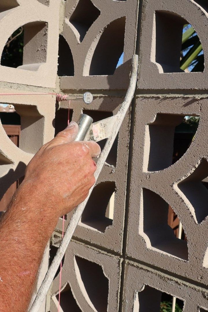 a man is working on a decorative wall