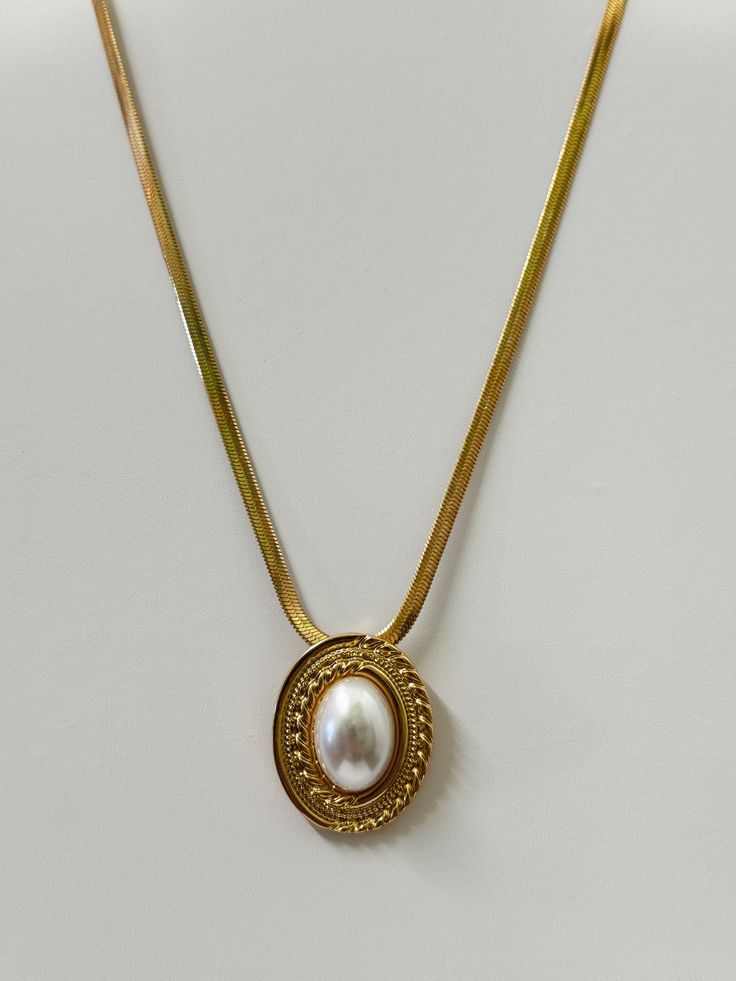 18k Vintage Gold Plating Faux Pearl Pendant Size: 1" x 1.25" Chain Length: 16" Extension Length: 2" Gold Necklace With Pearl Chain And Oval Pendant, Classic Gold Pearl Necklace With Chain, Gold Oval Pendant Necklace With Clavicle Chain, Gold Oval Pendant Chain Necklace, Tarnish Resistant, Gold-plated Oval Choker Necklace, Gold Chain Necklace With Tarnish Resistant Oval Pendant, Gold Chain Necklace With Oval Pendant, Tarnish Resistant, Gold Metal Pendant Locket Necklace, Elegant Tarnish Resistant Locket Pendant Necklace