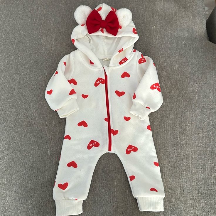 Never Worn. Great Condition. Hood Has Fuzzy Bear Ears And Red Bow. Has Red Zipper And Read Hearts All Over. Size 70 Which Is 9-12 Mos Red Long Sleeve Onesie For Playwear, Red Long Sleeve Onesie For Play, Cute White Hooded Onesie, Cute Hooded Onesie For Playtime, White Cotton Hooded Onesie, Cute White Onesie For Winter, Red Winter Onesie For Playtime, Red Onesie For Playtime In Winter, Cute White Winter Onesie