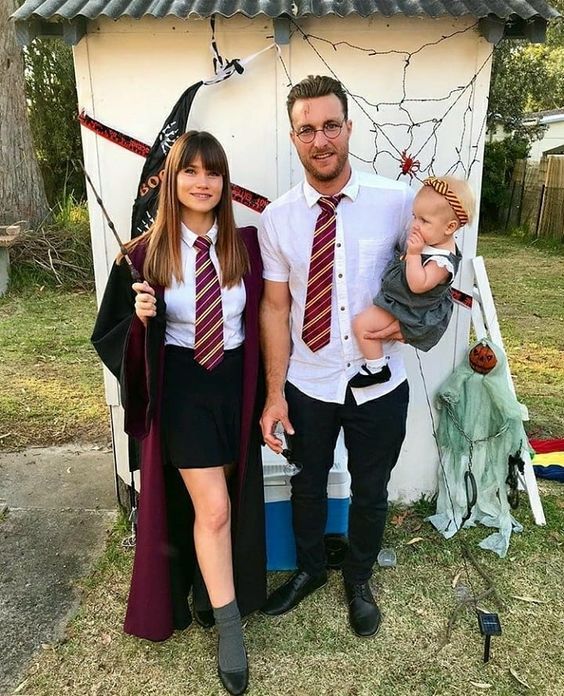 a man and woman are dressed up as harry potter and her son, who is holding a baby