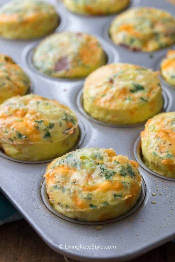 several muffins with cheese and broccoli in a pan