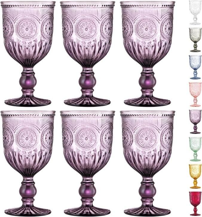 a set of six glass goblets sitting next to each other on a white background