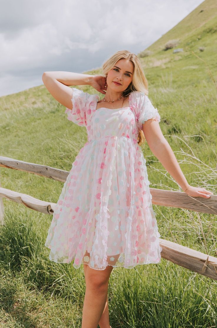 Upgrade your wardrobe with our Exclusive Pretty As A Petal Dress! This stunner features ombre rainbow floral applique, puff sleeves, and a stretchy bodice with tulle lining - making you ready to show off your unique style with confidence. Plus, each dress is available in inclusive sizes XS-6XL! Details Knee/Midi length Ombre rainbow floral Floral applique on tulle fabric Puff sleeve Tiered skirt Fully lined Stretchy bodice Elastic on sleeves and neckline Sizing*Measurements are taken with item h Knee Length Hoco Dresses, Dance Proposals, Modest Homecoming Dresses, Sunday Dresses, Eras Outfit, Petal Dress, School Formal, Curvy Dresses, Church Fits