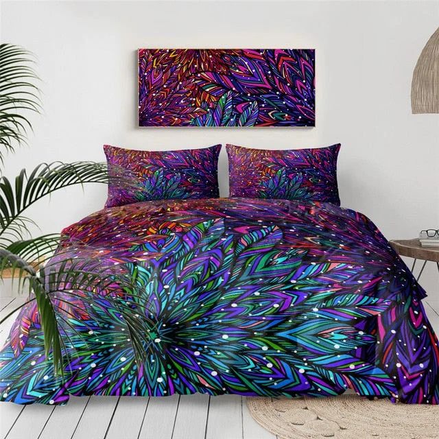 a bed covered in purple and blue comforter next to a potted plant