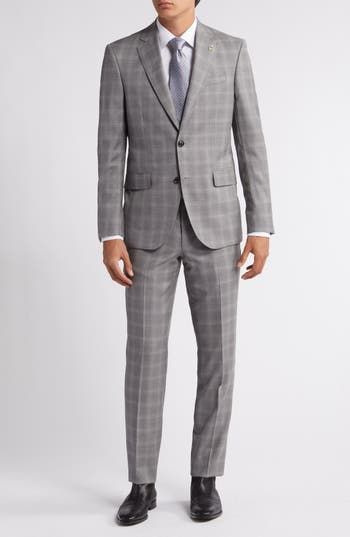 Grey Italian wool woven in a chalky plaid distinguishes a suit that's styled with traditional detailing to make it a smart addition to any formal wardrobe. Jacket has notched lapels; four-button cuffs; chest pocket; flap pockets; side vents Trousers have zip fly with button-tab closure; slant pockets; back button-welt pockets Jacket is lined Unhemmed 100% wool Dry clean Made in Canada Elegant Plaid Blazer With Notch Lapel, Timeless Plaid Suit For Work, Timeless Plaid Suits For Work, Elegant Plaid Business Suit, Timeless Plaid Suit With Notch Lapel, Timeless Plaid Suits With Notch Lapel, Elegant Plaid Blazer For Business, Elegant Plaid Blazer, Elegant Plaid Semi-formal Blazer