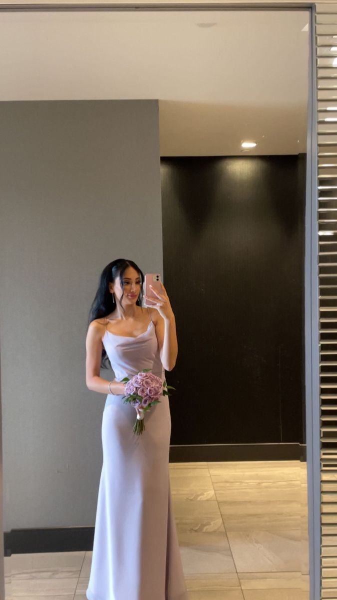 a woman is taking a selfie in front of a mirror wearing a wedding dress