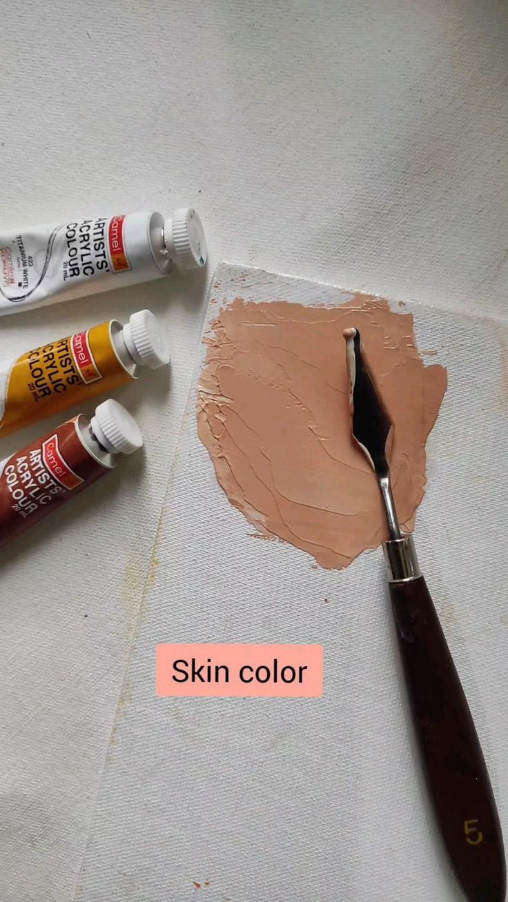 three different types of paint and a brush on a piece of paper with the words skin color next to it