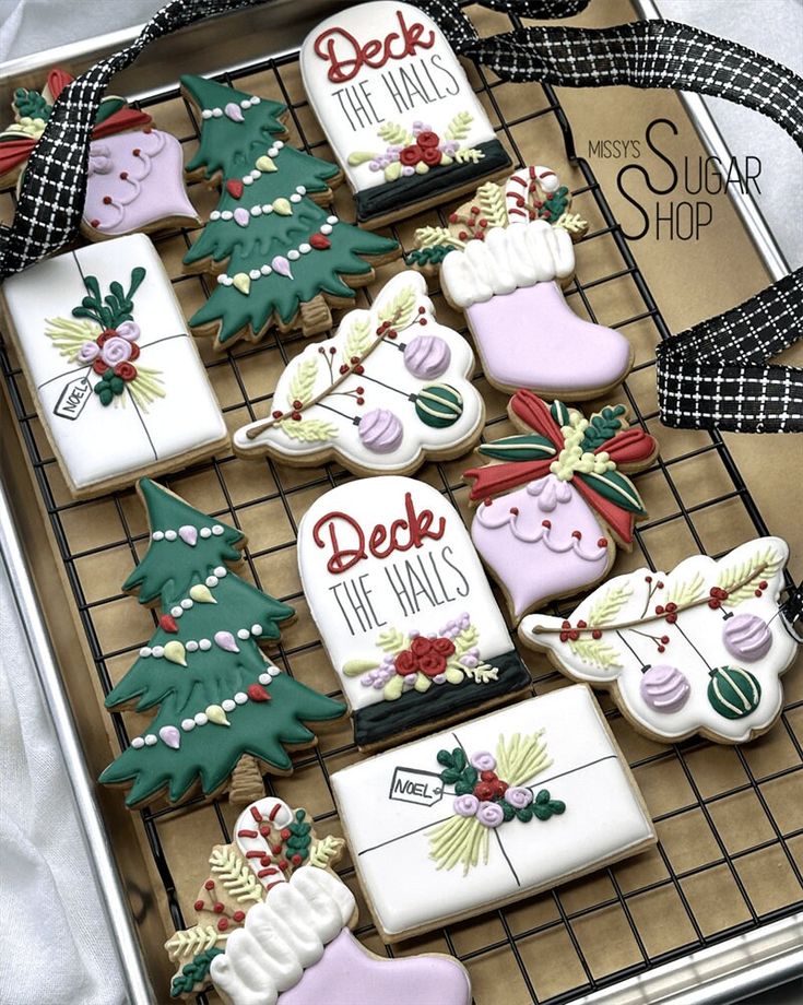 decorated christmas cookies on a cooling rack with ribbons and ribbon around the edges that says deck the nails