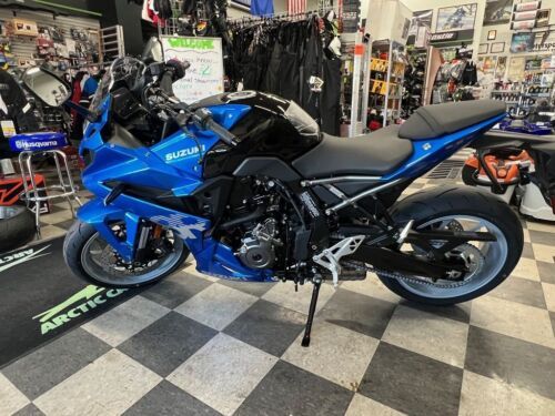 a blue motorcycle is parked in a showroom