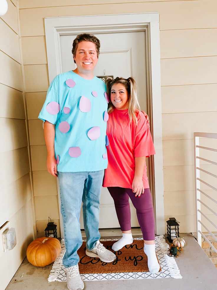 a man and woman standing in front of a door