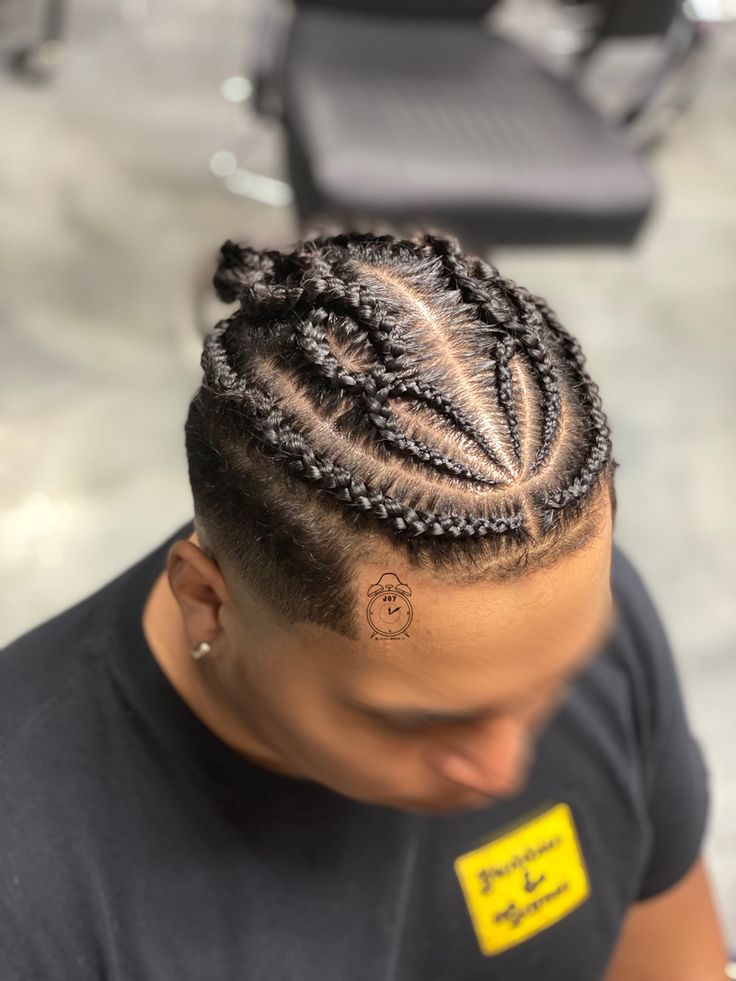 A total of six stitch braids on the top section of a man’s head. The two on the very outer edges, respectively, follow the hairline around and back. The four braids in the middle are sectioned off into two separate criss-crossing braids down the center of the head. Each braid criss-crosses twice, giving the design a unique appearance. All six braids meet in the back to combine into one small bun. Cross Over Braids Men, Criss Cross Braids Men, Oval Face Men, Straight Back Braids, Prom Braid, Braid Styles For Men, Back Braid, Mens Hairstyle, Men's Short Hair