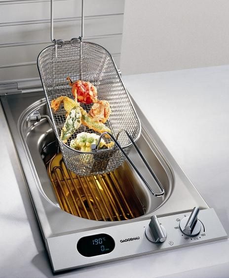 a fryer filled with food sitting on top of a stove