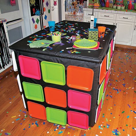 an image of a birthday party table in the middle of a room with confetti all over it