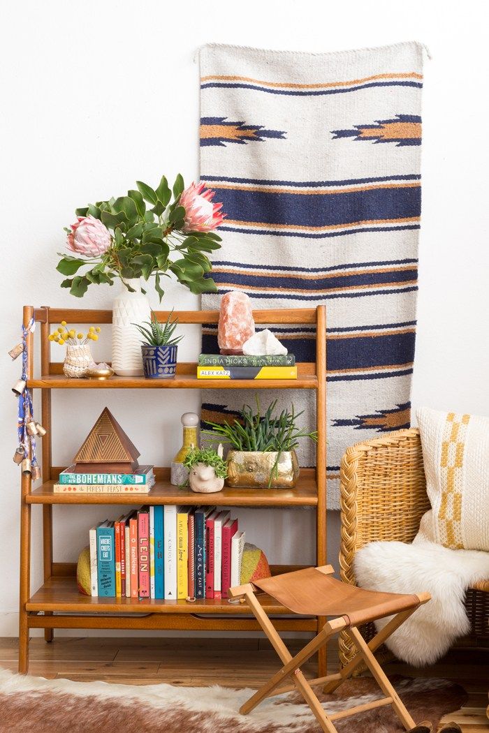 a book shelf with books and plants on it