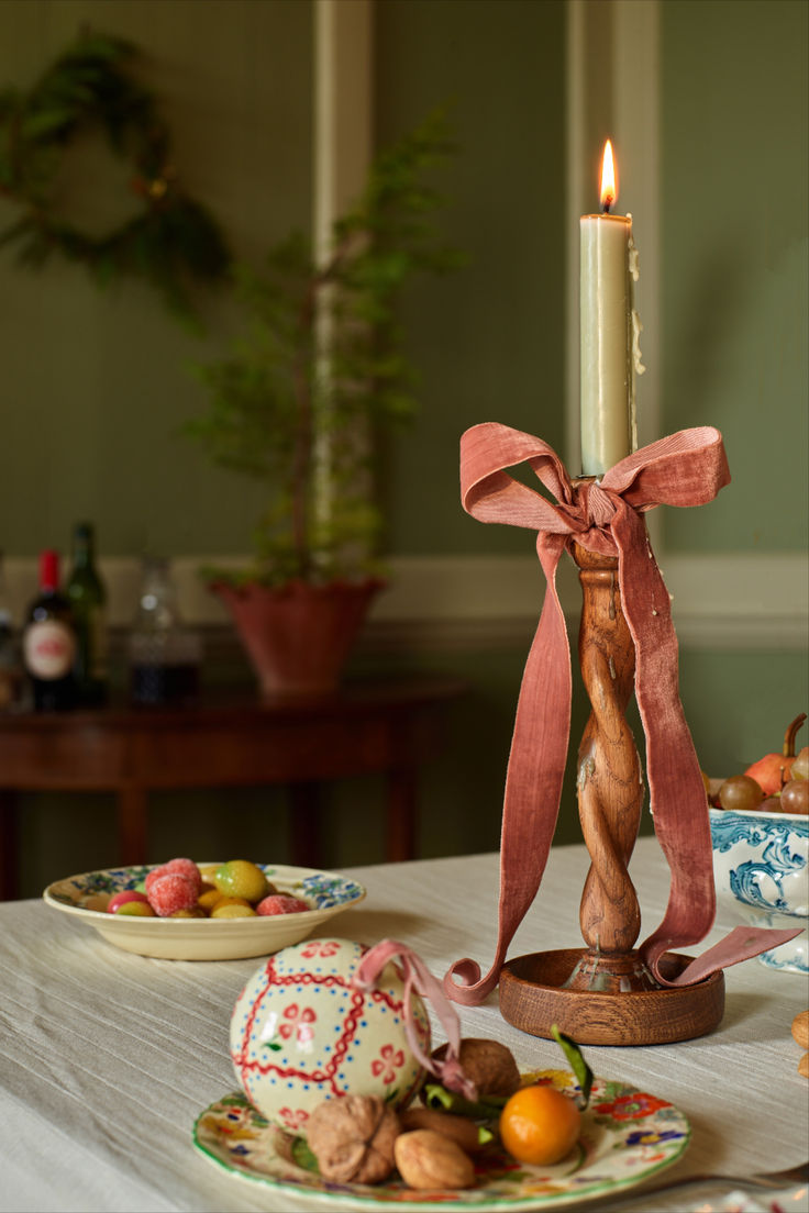 a table topped with plates covered in food and a candle