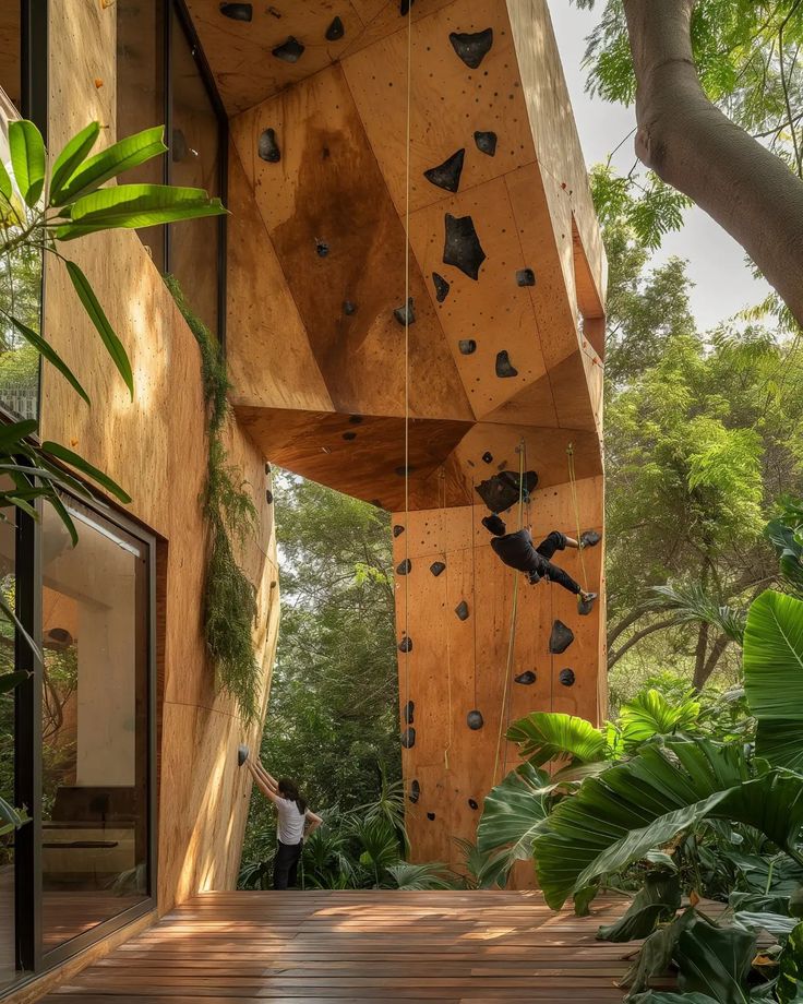 a person climbing up the side of a wooden structure in a jungle like area with trees and plants