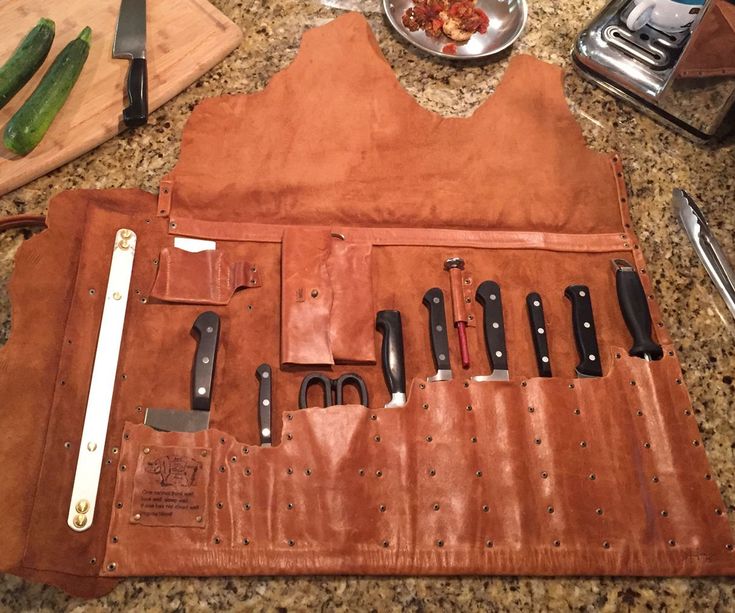 a leather case with knives and other kitchen utensils