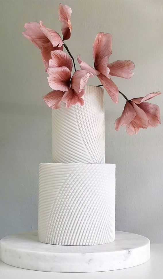 a white cake with pink flowers on top