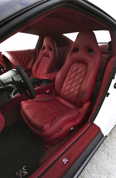 the interior of a car with red leather seats