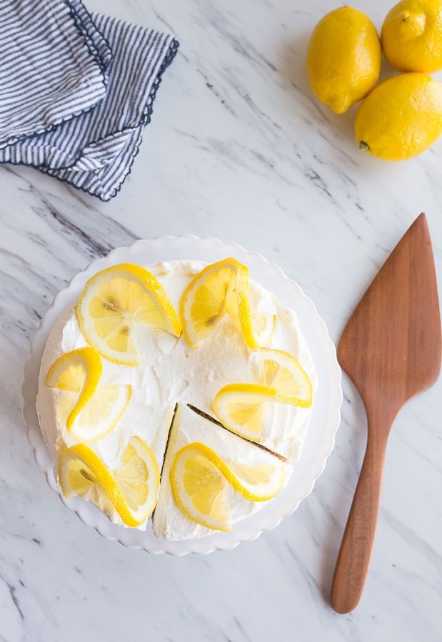 a cake with lemons on it and a wooden spoon