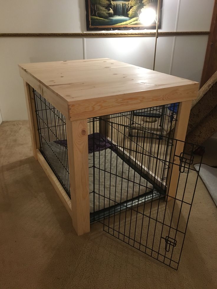 a dog cage with a wooden table on the top and metal bars at the bottom