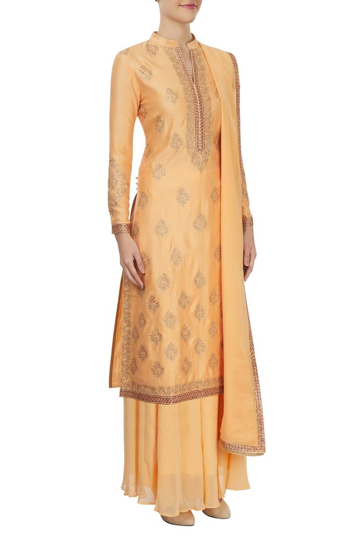 Peach long kurta with all-over dori embroidered motifs in gold accents. Paired with palazzo and a dupatta.
Components: 3
Pattern: Embroidered
Type of Work: Dori work
Neckline: V-neck
Sleeve length: Full
Fabric: Chanderi
Color: Peach
Other details:
Side slits
Ethnic motifs - Aza Fashions Formal Festive Sharara With Gold Embroidery, Formal Embroidered Chanderi Palazzo Set, Semi-stitched Salwar Kameez With Gold Embroidery For Formal Occasions, Formal Semi-stitched Salwar Kameez With Gold Embroidery, Formal Salwar Kameez With Gold Embroidery, Semi-stitched Silk Traditional Wear With Gold Embroidery, Gold Palazzo Set With Zari Work For Formal Occasions, Traditional Salwar Kameez With Gold Embroidery For Formal Occasions, Unstitched Suit With Gold Embroidery For Designer Wear