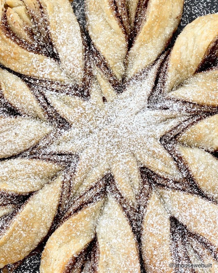 a star shaped pastry with powdered sugar on top