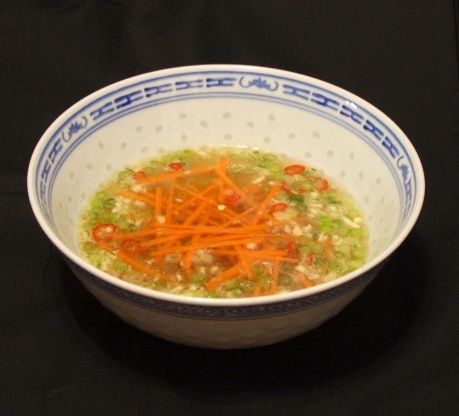 a bowl of soup with carrots and celery