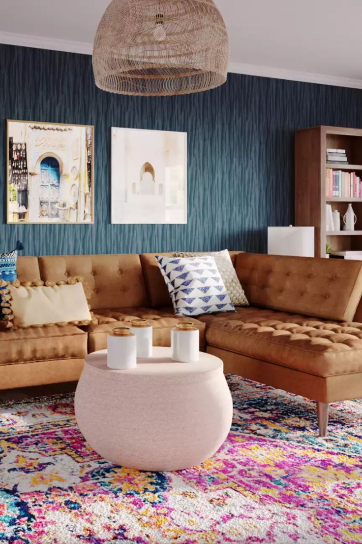 a living room filled with lots of furniture and colorful rugs on top of it