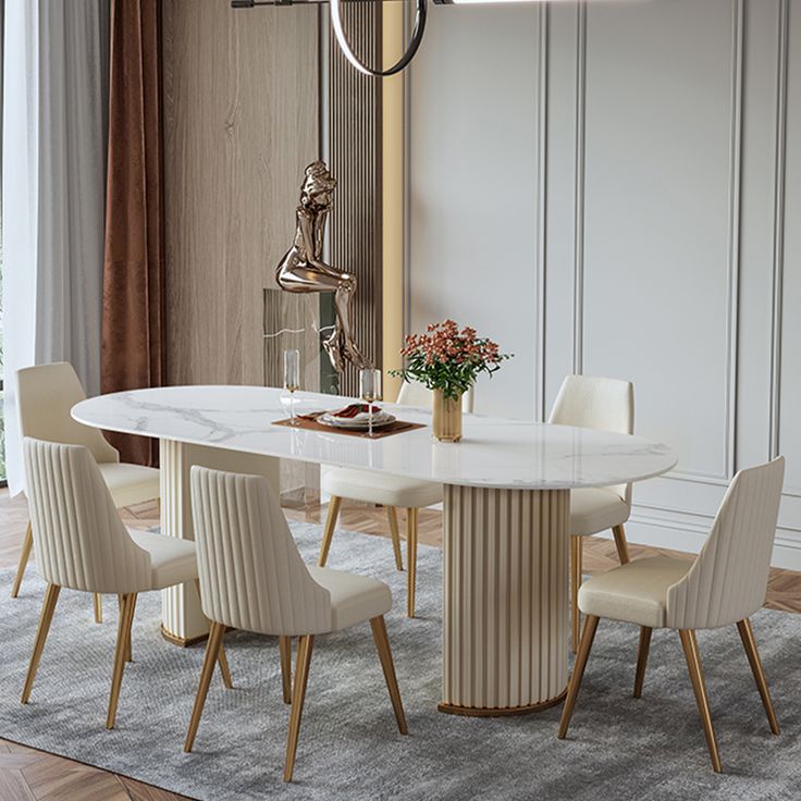 a dining room table with chairs and a vase on the table in front of it