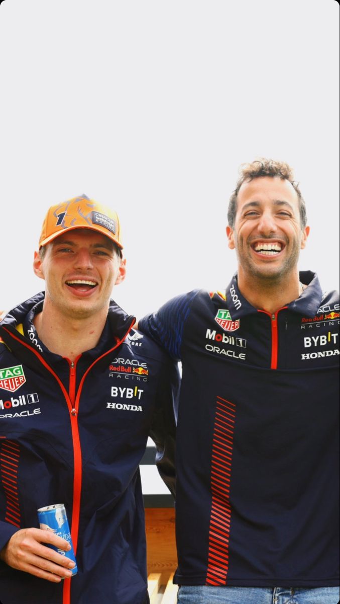 two men standing next to each other smiling