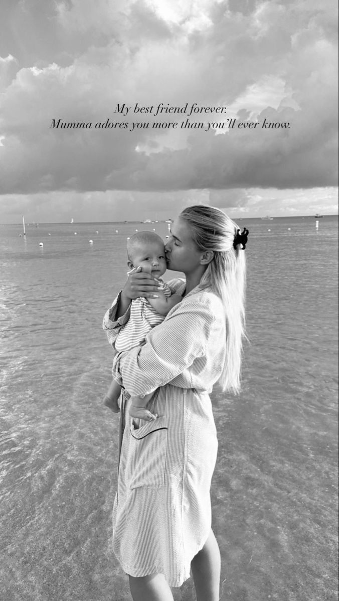 a black and white photo of a woman holding a baby in her arms with the caption, my first friend forever