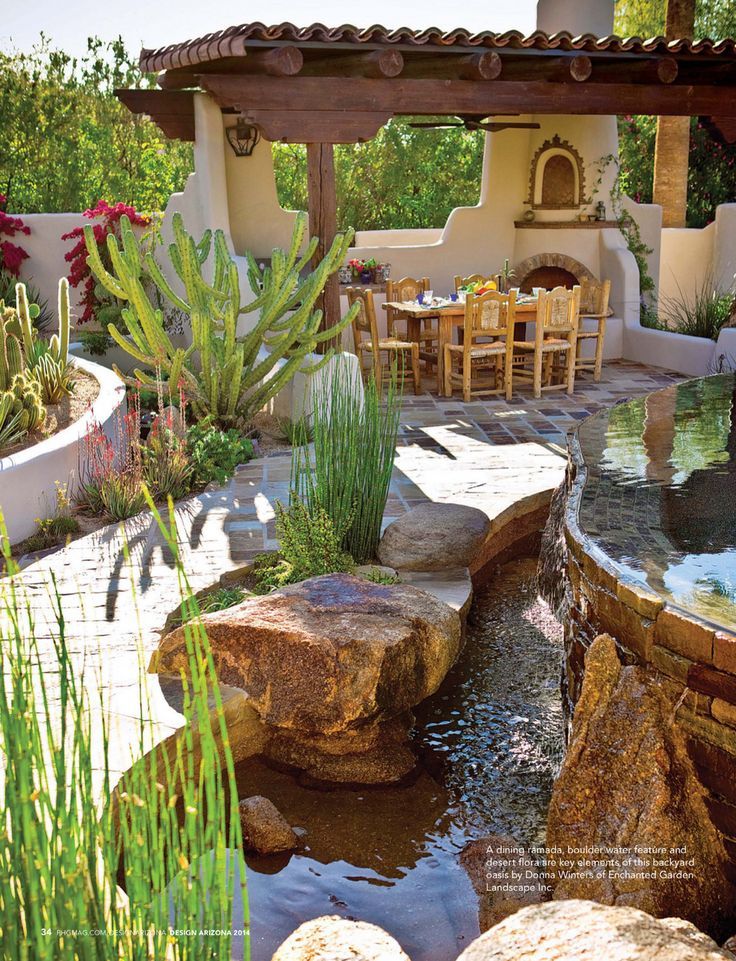 an outdoor dining area with water feature and seating