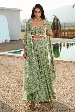 Pista split sleeve cape with all over tropical trees and pineapple print. Paired with an inner bustier with all over tropical trees print and palazzo. - Aza Fashions Party Wear Indian Dresses For Summer, Indowestern Bridesmaid Dresses, Luxury Pista Green Palazzo Set With Traditional Drape, Fitted Traditional Wear For Festive Occasions, Luxury Summer Traditional Wear In Georgette, Luxury Traditional Wear For Spring Formal Occasions, Infian Inspired Western Dresses, Kurta And Skirt Set, Tropical Indian Wedding Outfit