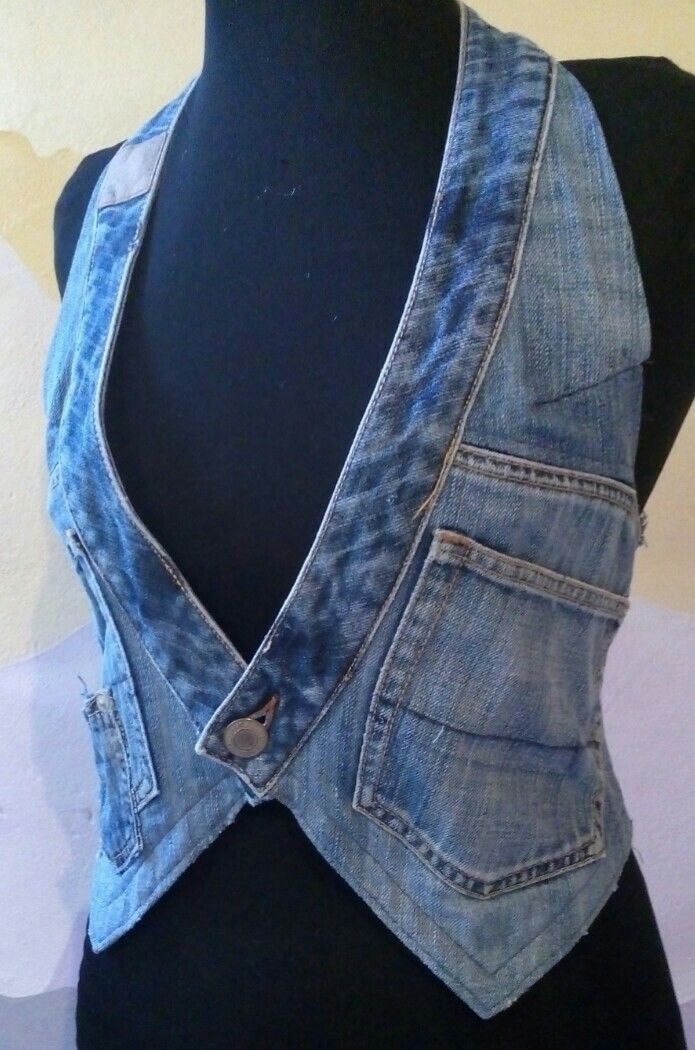 a black mannequin wearing a blue jean vest