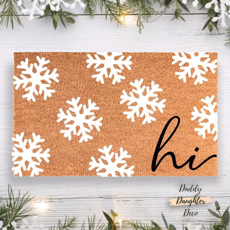 a door mat with snowflakes on it and the word hi written in black