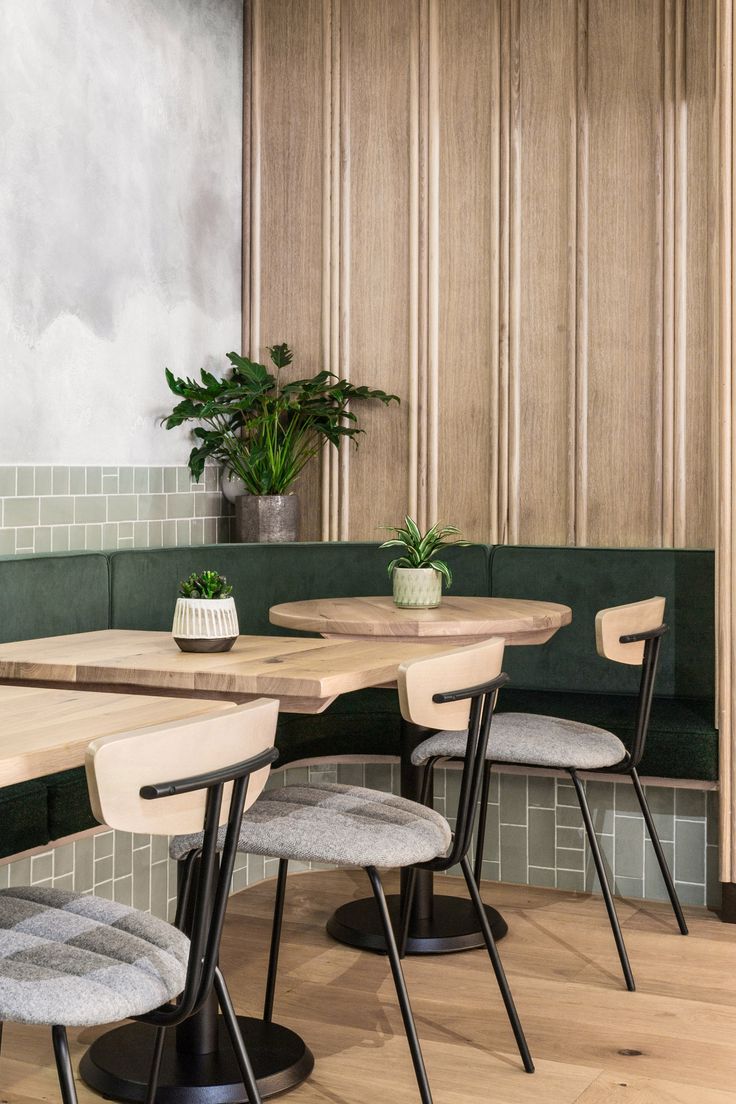 two black chairs sitting at a wooden table