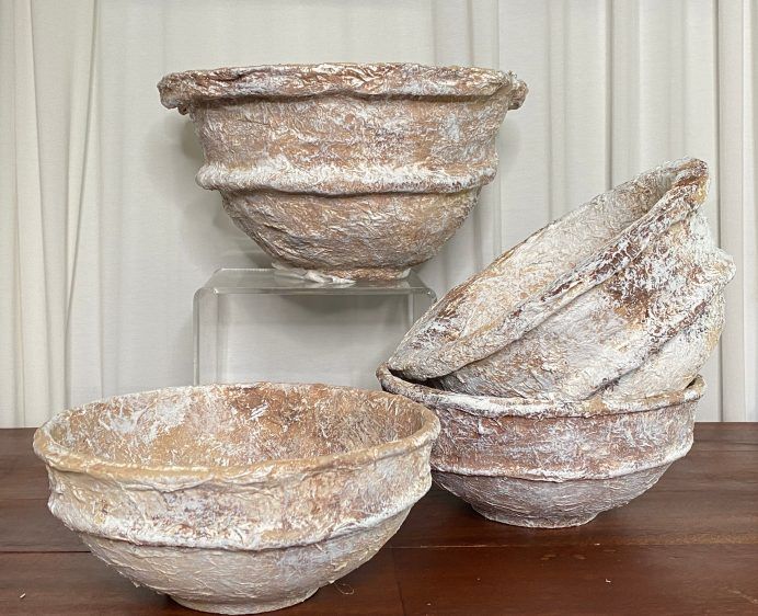 three white bowls sitting on top of a wooden table