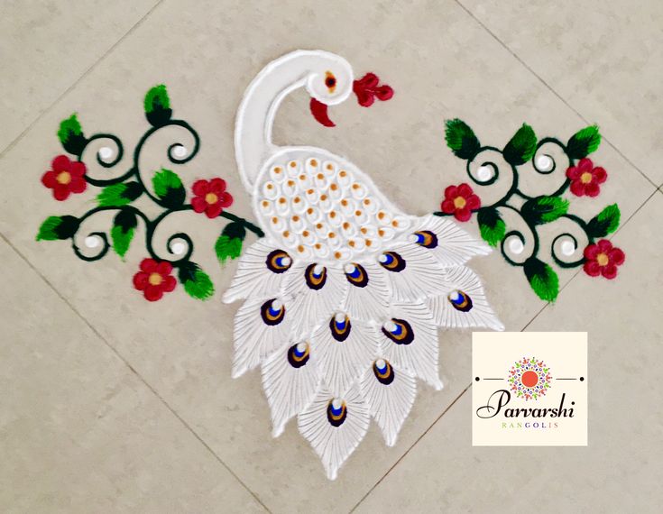 a white peacock sitting on top of a tile floor next to red and green flowers