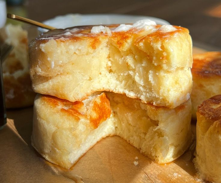 several pieces of bread sitting on top of a wooden cutting board