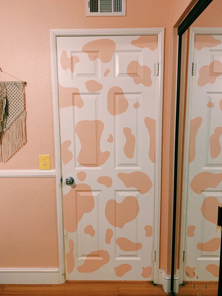 the door is painted pink and white with brown spots on it's side wall