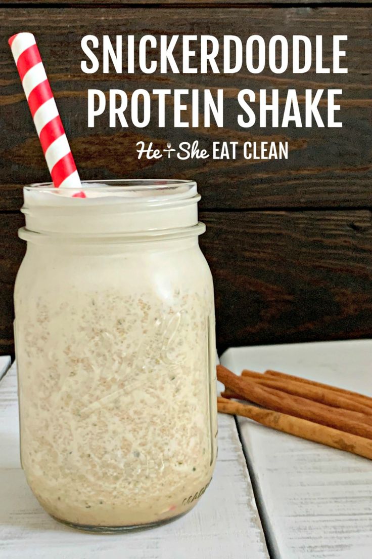 a jar filled with protein shake next to cinnamon sticks