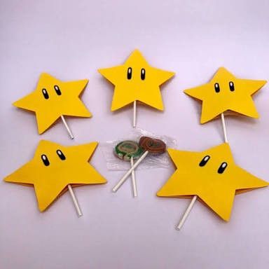 five yellow star shaped lollipops sitting on top of each other with buttons