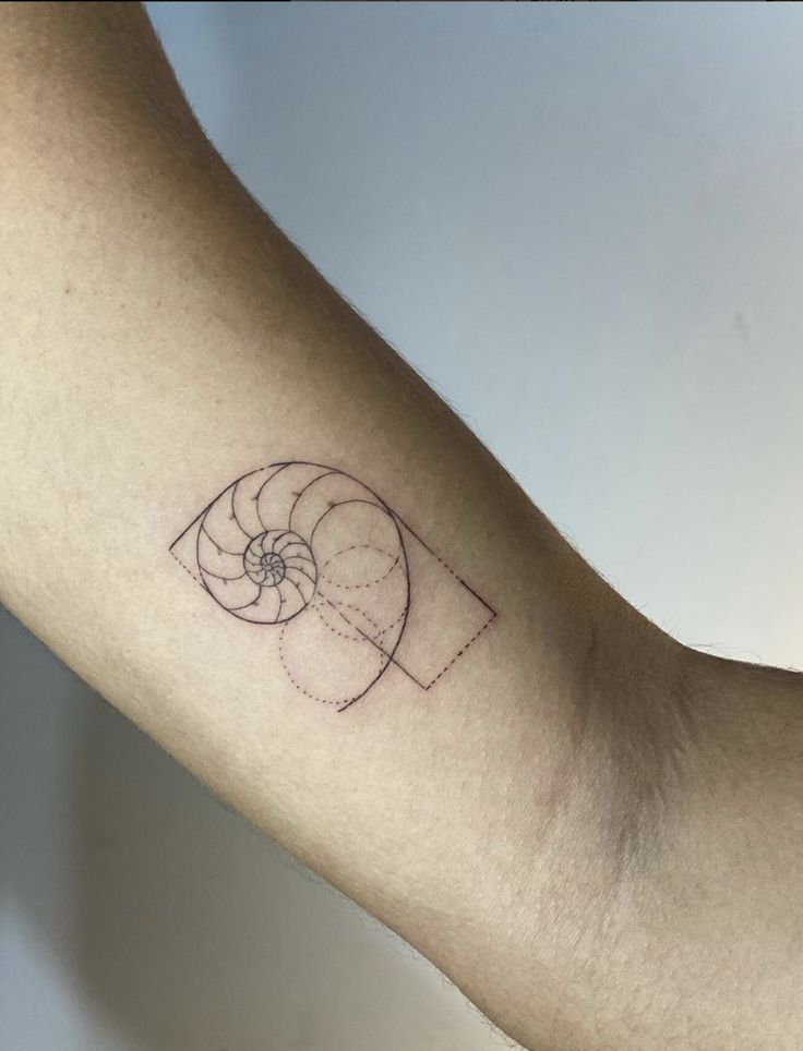 a person's arm with a small tattoo on it